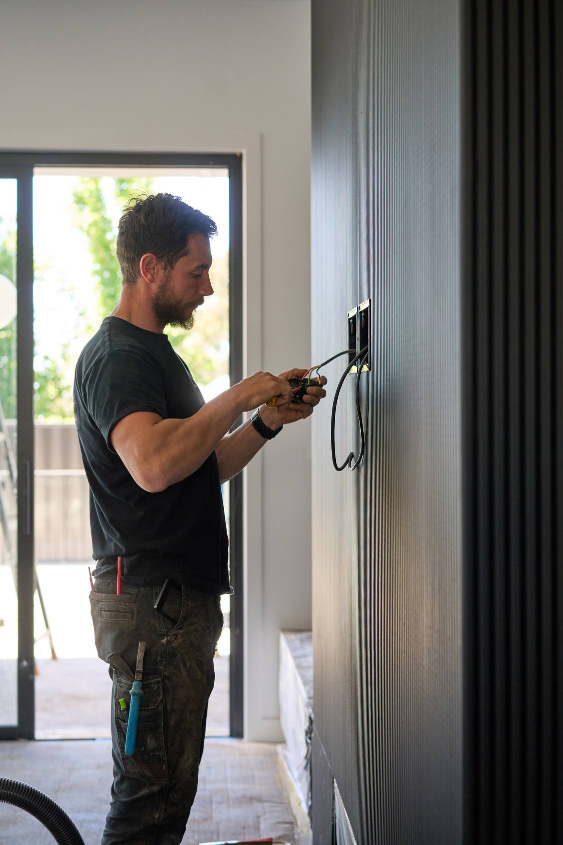 Electrician installing a wall switch